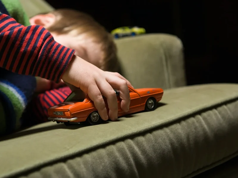boy-playing-with-a-toy-car