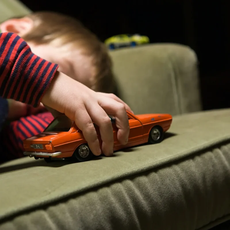 boy-playing-with-a-toy-car